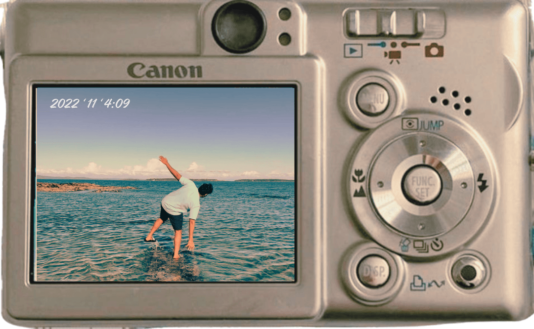 Back of an old Canon point-and-shoot, its screen showing a 2022 skimboarding photo